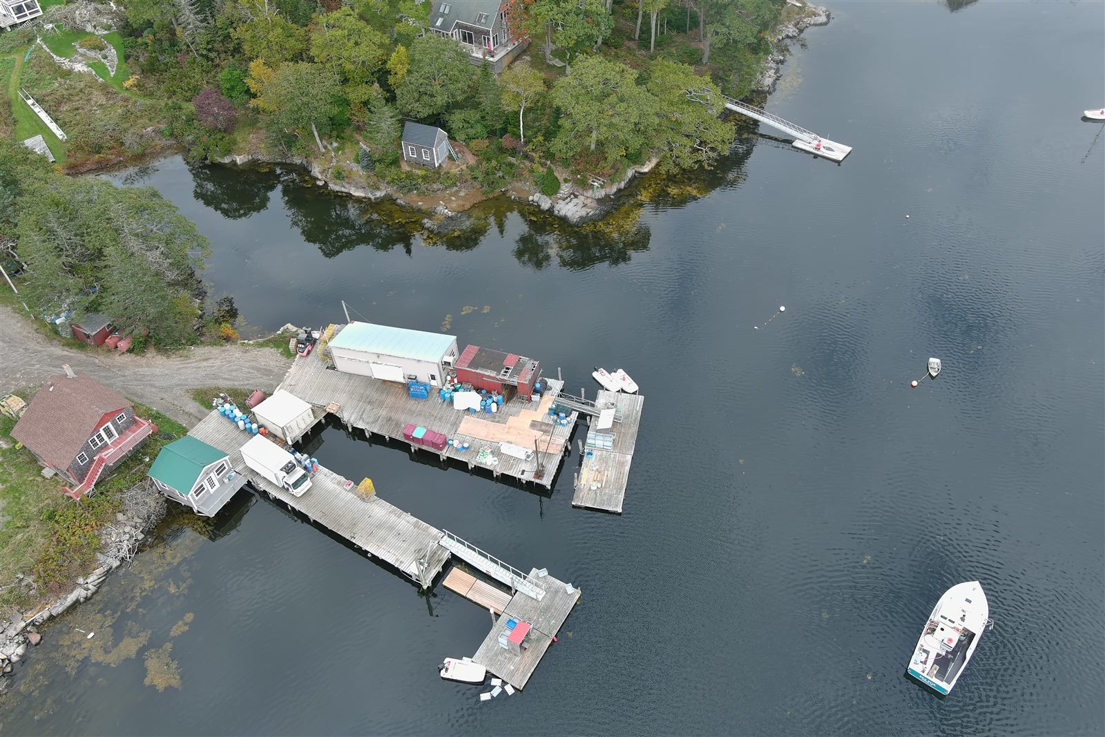 Overhead view of waterfront buildings, piers, boats, and road access